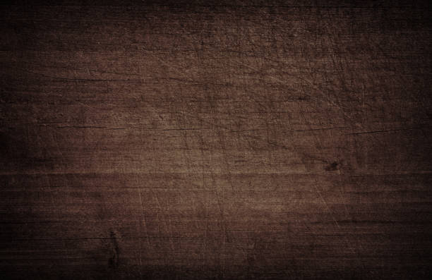 istock Dark brown scratched wooden cutting, chopping board. Wood texture 871109648