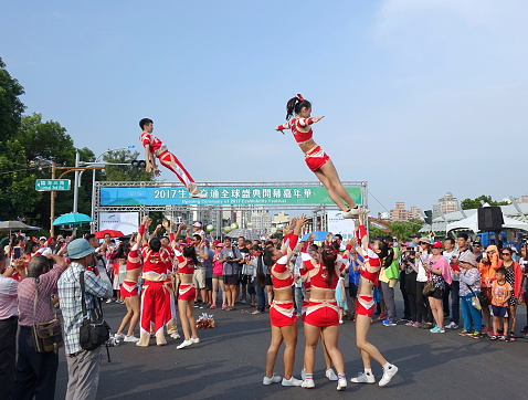 KAOHSIUNG, TAIWAN -- OCTOBER 1, 2017: Cheerleaders perform acrobatics at the opening of the 2017 Ecomobility Festival.