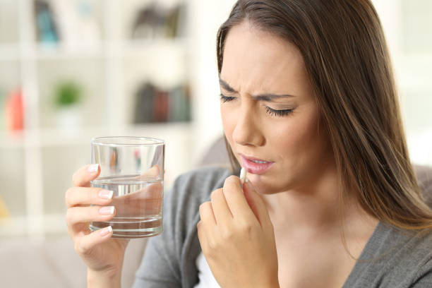istock Painful woman taking a pill 871124638