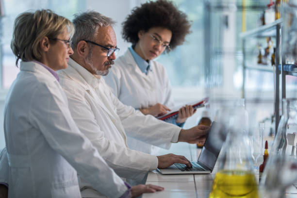 istock Group of scientists analyzing medical data on laptop in the laboratory. 871125052