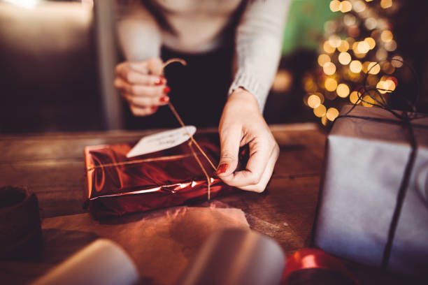 istock woman making the package for the christmas gift 871125288