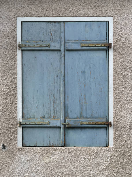 istock Architectural detail - window with closed blue wooden shutter 871126576