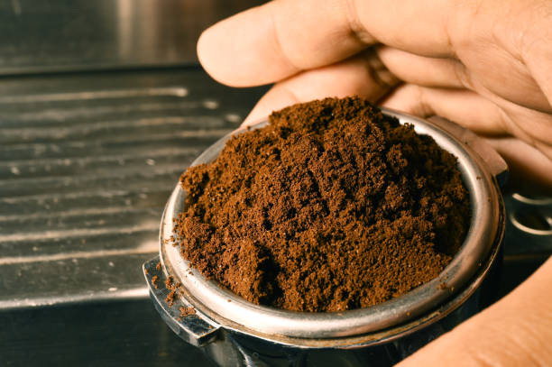 istock Freshly ground coffee beans in a metal filter on hand 871126840