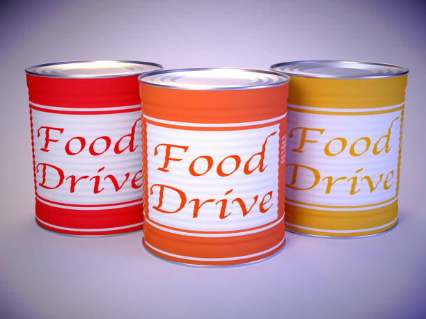 istock Three cans in red orange yellow on white with the words food drive 871136744