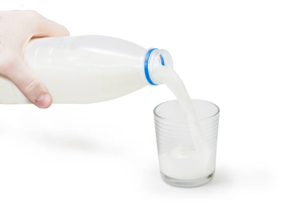 istock Milk is poured from a bottle into a glass 871137160