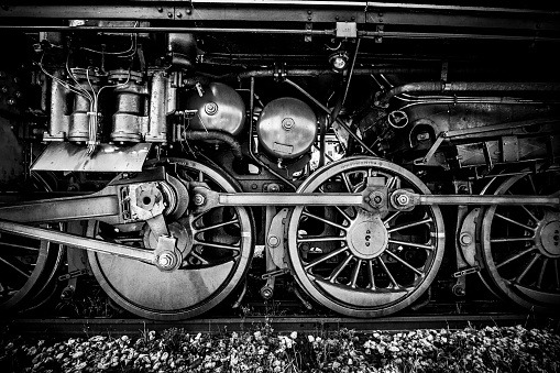 Wheels of an old steam locomotive, black and white image