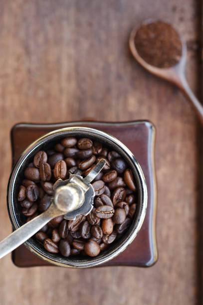 istock cup of coffee and coffee beans in coffee grinder 871138558