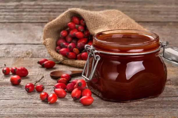 Freshly prepared homemade jam made of briar on a wooden surface