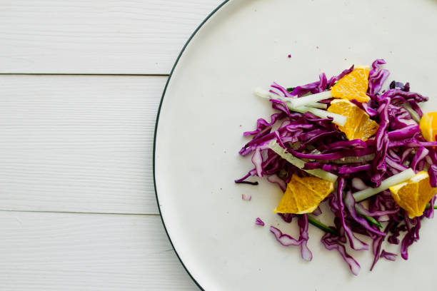 istock Red cabbage salad with orange on white dish 871144768