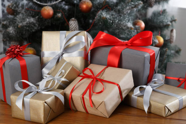 istock Christmas present on decorated tree background, holiday concept 871146028