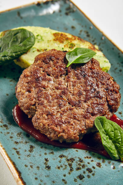 istock Grill Beef Cutlet with Green Leaves and Potato Mash 871149368