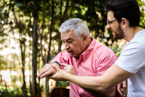 istock Dad interacting with his new digital watch, son happy for that 871153848