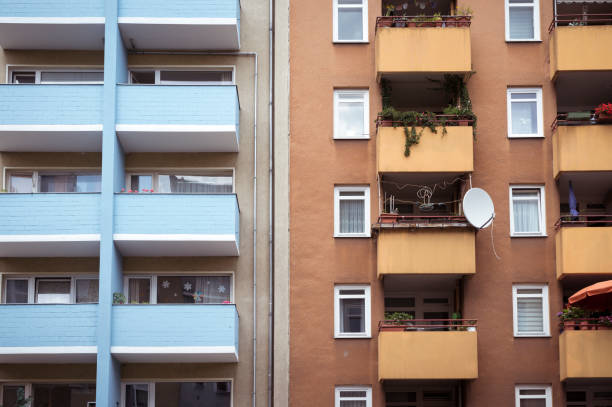istock poor houses, blue and orange balconies 871157440