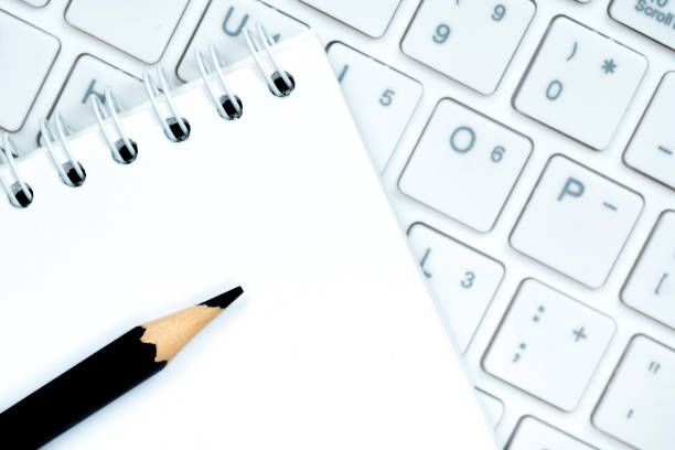 istock white keyboard with notepad and black pencil, journalism concept 871158130