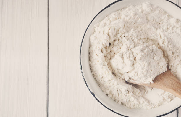istock Making dough, baking. Bowl with flour on wood desk 871162216