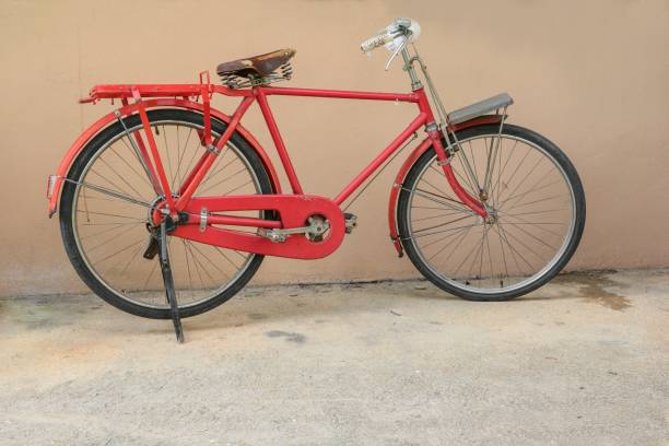 istock bicycle red  classic vintage in former on road background with copy space for add text 871166846
