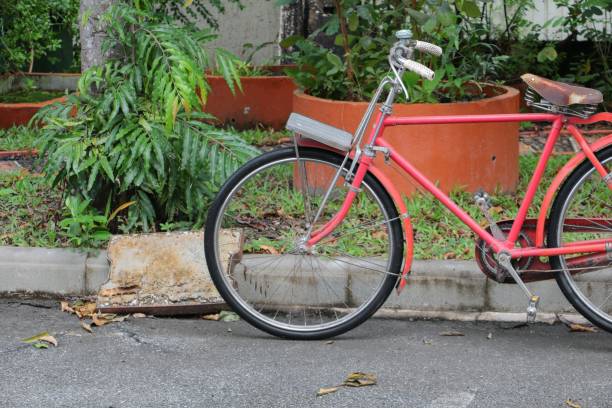 istock bicycle red  classic vintage in former on road background with copy space for add text 871166888