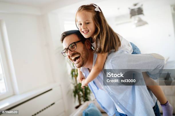 Portrait Of Father And Daughter Playing At Home Stock Photo - Download Image Now - Father, Daughter, Piggyback