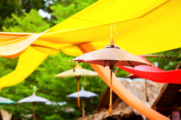 istock Yellow huge scarf and umbrellas between trees 871169302