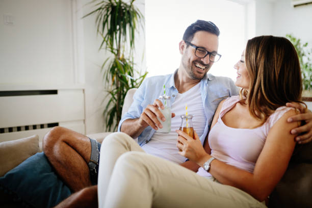 istock Young happy couple drinking together at home 871169606