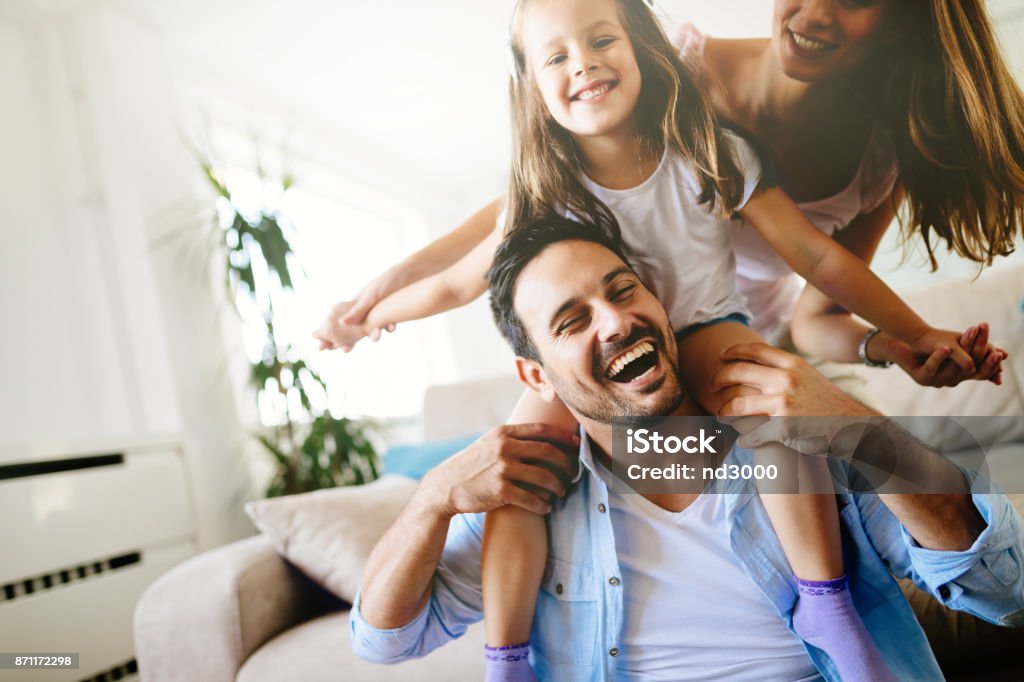 Happy family having fun times at home Happy family having fun times at home together Family Stock Photo