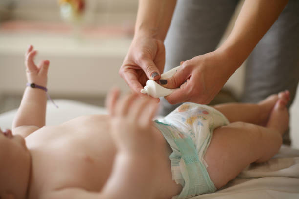 Mother and naked baby, skin care. stock photo