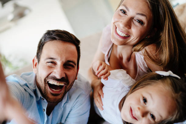 istock Happy family taking group selfie at home 871172840