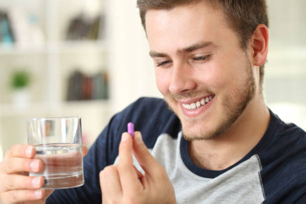 istock Happy man ready to take a capsule 871172924