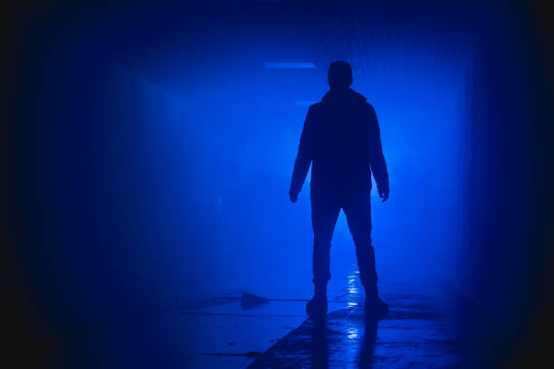 istock Silhouette standing man with in the darkness 871173022