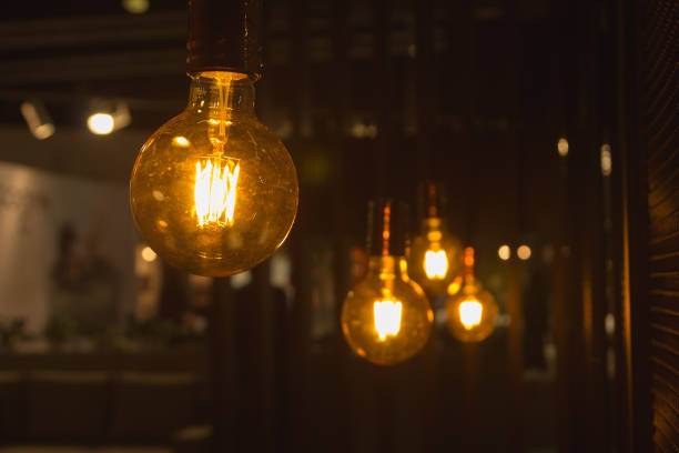 istock A glowing light bulbs. Light bulbs on a dark background with copy space. 871173062
