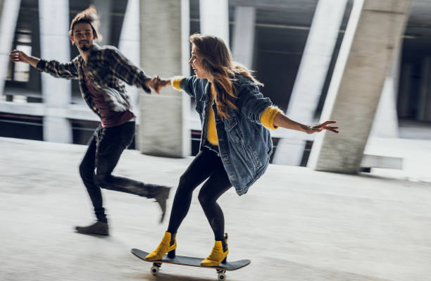 istock Two Young Teenagers Holding Hands, Skateboarding 871175824