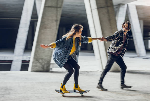 istock Two Young Teenagers Holding Hands, Skateboarding 871175828