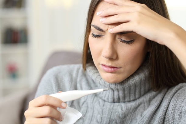 istock Ill woman checking thermometer temperature 871177204
