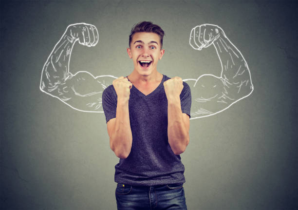 istock Successful man winning fists pumped celebrating success flexing muscles 871179916