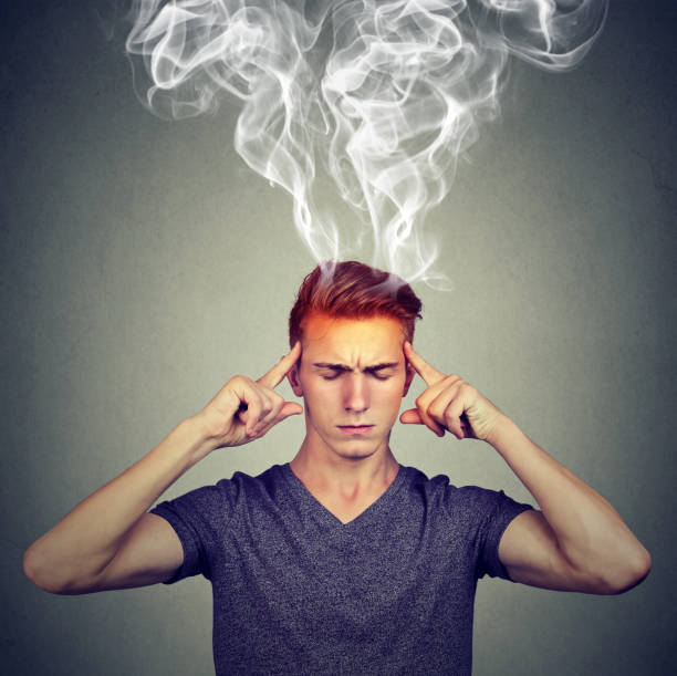 istock man thinks very intensely having headache isolated on gray wall background 871179954