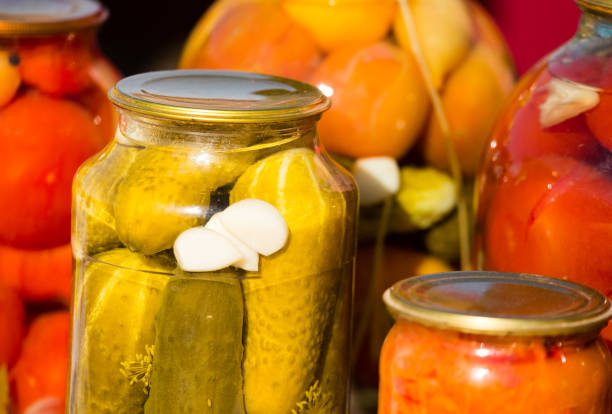istock canned cucumbers and tomatoes in glass jars 871182654