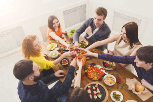 istock People say cheers clink glasses at festive table dinner party 871189358