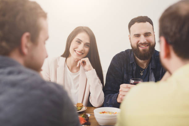 istock Happy people talking at festive table dinner party 871189446