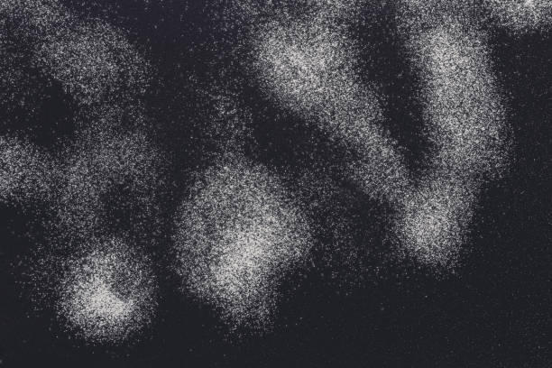 istock Sprinkled wheat flour splash spots on black background 871193150