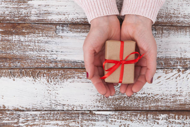 istock Present. Gift box. Woman holding small gift box with ribbon. 871193386