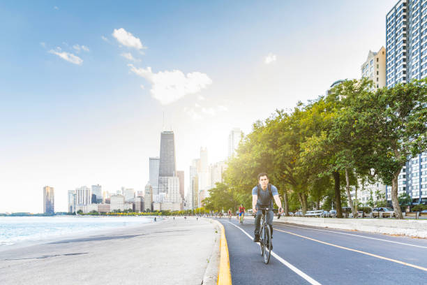 istock Man cycling in Chicago with city on background 871195914