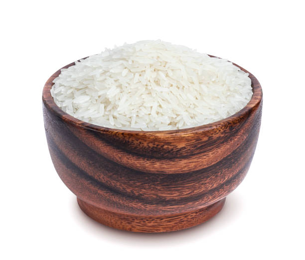 istock Jasmine rice in wooden bowl isolated on white background 871195976