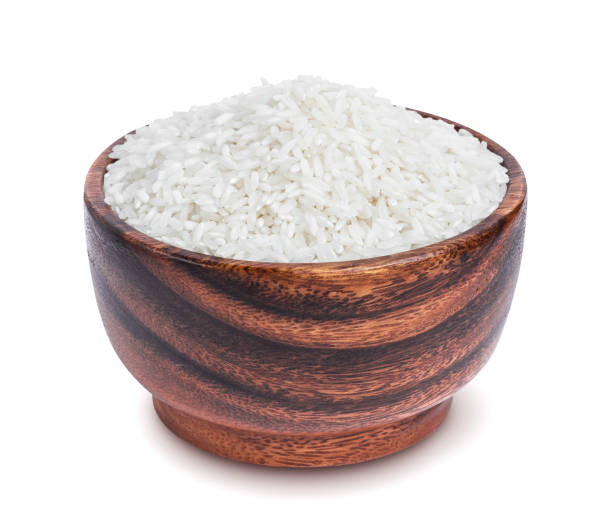 istock Basmati rice groats in wooden bowl isolated on white background 871196132