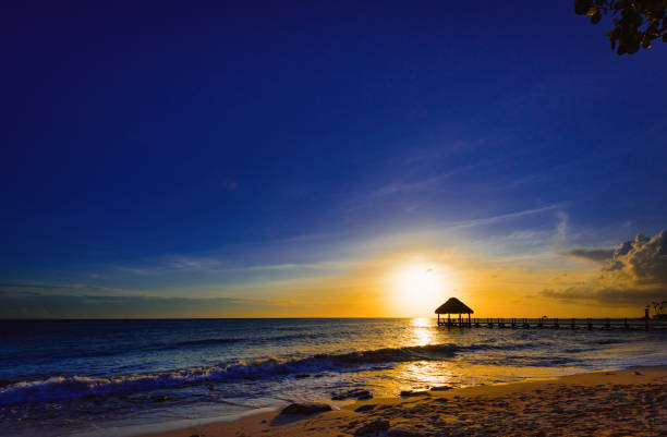 tropical sea sunset in the cloud at the resort gazebo in the water, the Caribbean Sea Dominican Republic