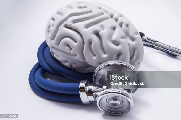 The Figure On The Brain Is On Twisted Into A Spiral Tube Of The Stethoscope With Chestpiece Which As It Listens To The Human Brain The Idea For The Diagnostic Imaging In Neurology And Neuroscience Stock Photo - Download Image Now