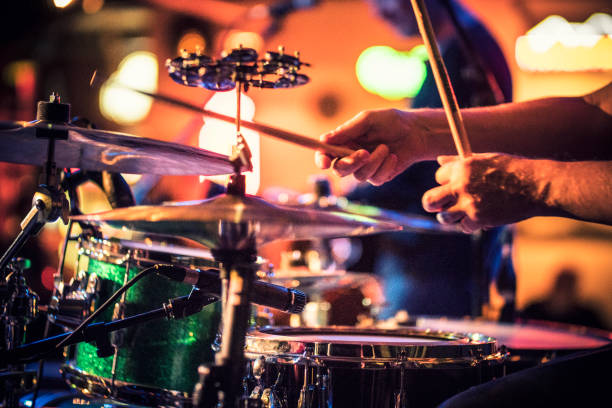 Drummer plays drums on stage Drummer plays drums on stage bass drum photos stock pictures, royalty-free photos & images