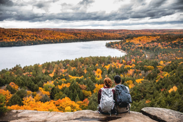 Young couple hiking in mountain and relaxing looking at view