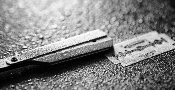 istock A dangerous razor and a metal blade on the table. Men's shaving 871207986