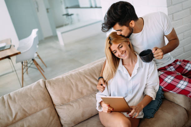 istock Young attractive couple spending time together at home 871208694