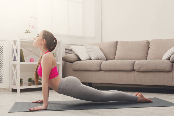 istock Woman training yoga in cobra pose. 871208874